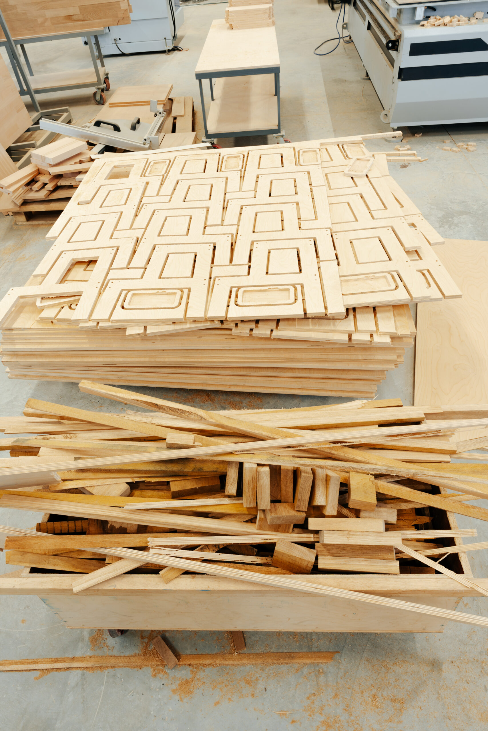 Stacked wooden bars in workshop of furniture manufacture close up